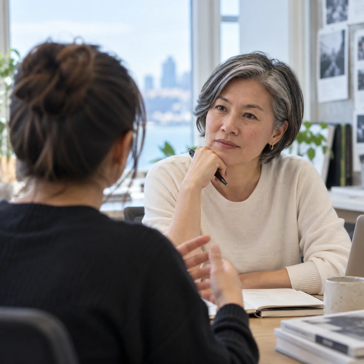 An experienced editor listening to an emerging professional.